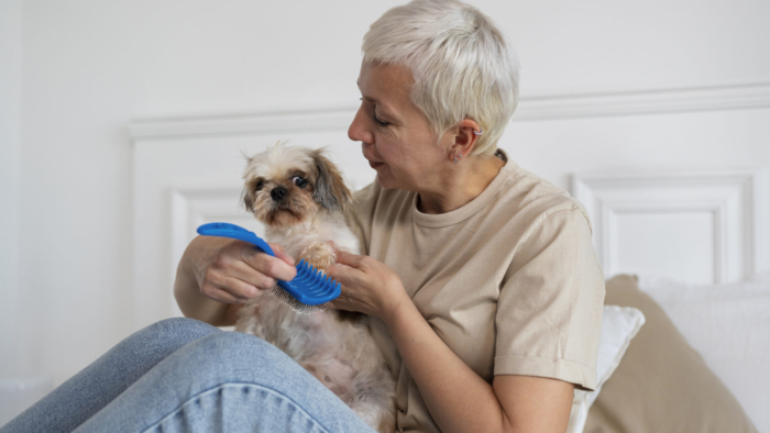 side-view-senior-woman-brushing-dog